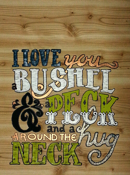 Acrylic painting of song lyrics on a wooden plaque.