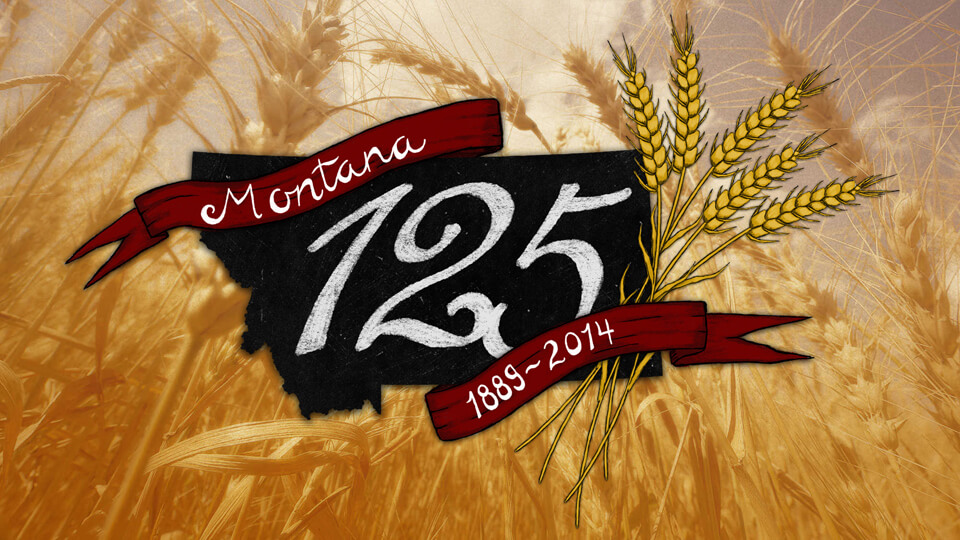 Photograph of wheat with the Montana 125th logo placed in the middle of the frame.