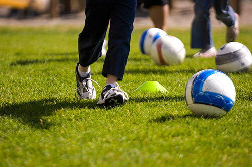 A group of young children practice dribbling during a recent youth soccer workshop held in Helena, Mont.