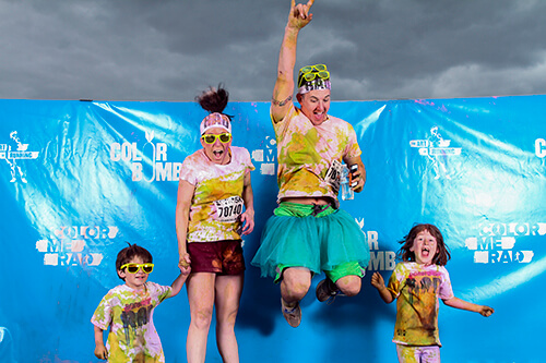 A family of racers poses for a portrait after finishing the &ldquo;Color Me Rad&rdquo; 5k.