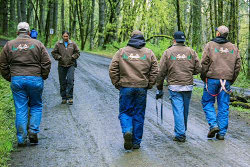 Competitors in matching Carhartt jackets head towards the Conclave grounds.