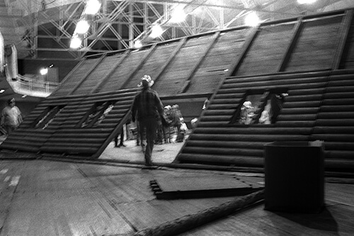 Raising the wall of one of the structures built for the Foresters' Ball.